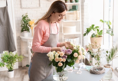 Female florist with roses at workplace