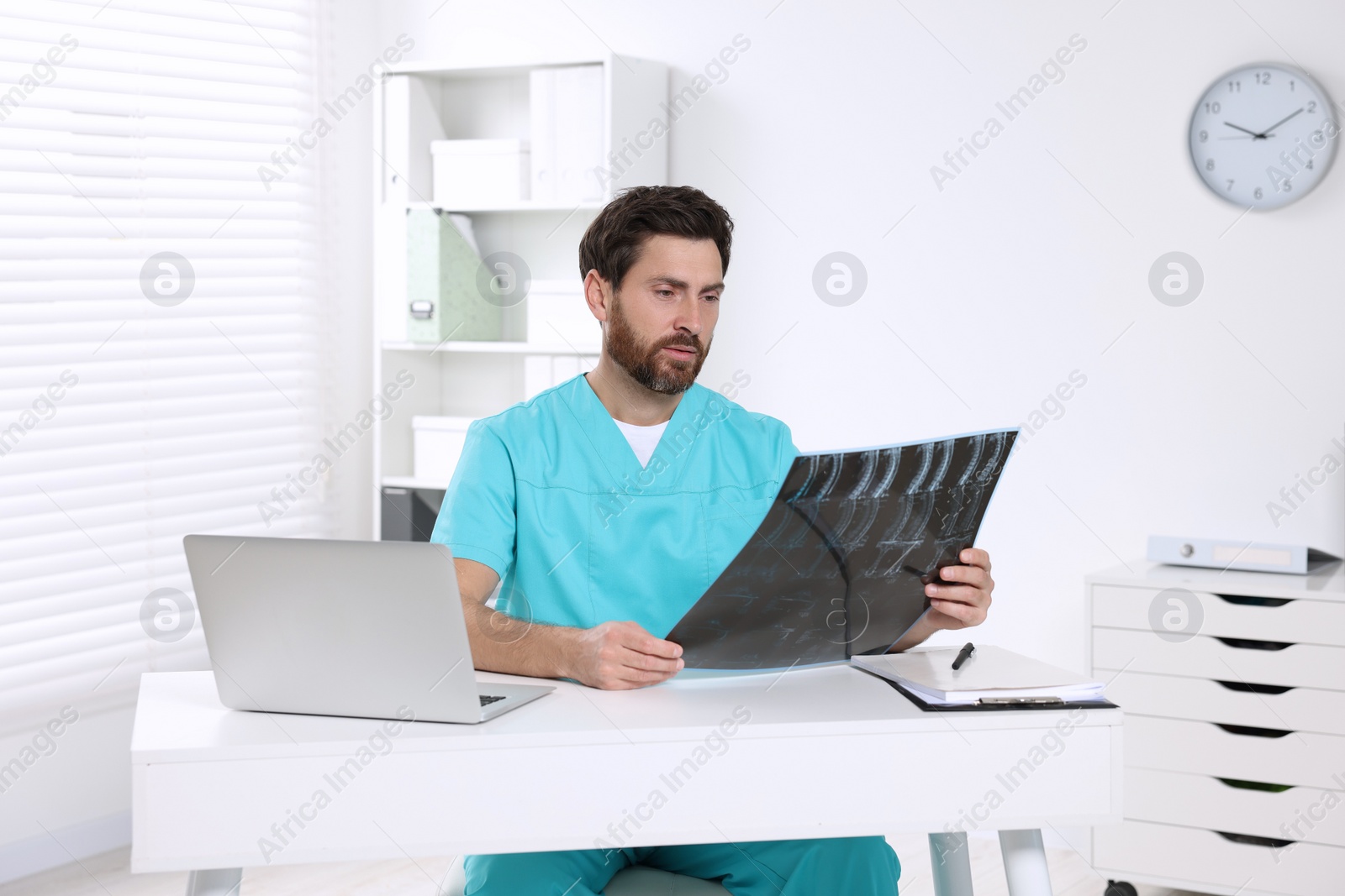 Photo of Doctor examining neck MRI scan in hospital