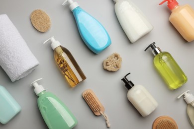 Photo of Flat lay composition with bottles of liquid soap on grey background