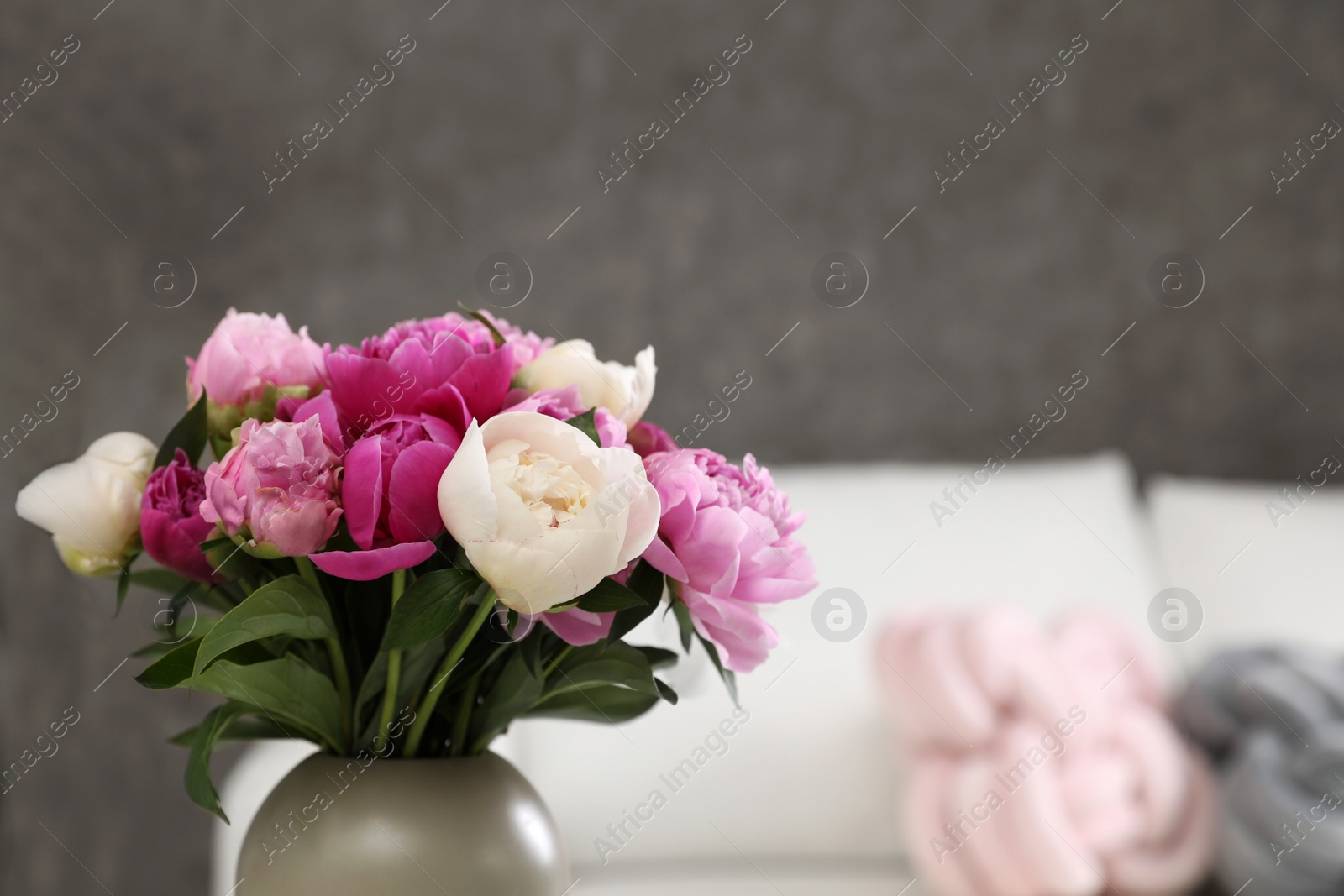 Photo of Vase with bouquet of beautiful peonies in room, space for text