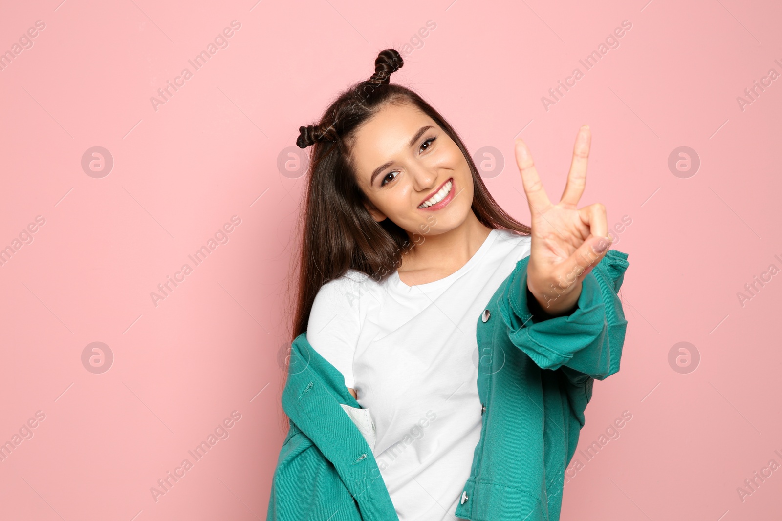 Photo of Portrait of beautiful young woman in stylish clothes on color background