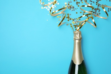 Photo of Creative flat lay composition with bottle of champagne and space for text on color background