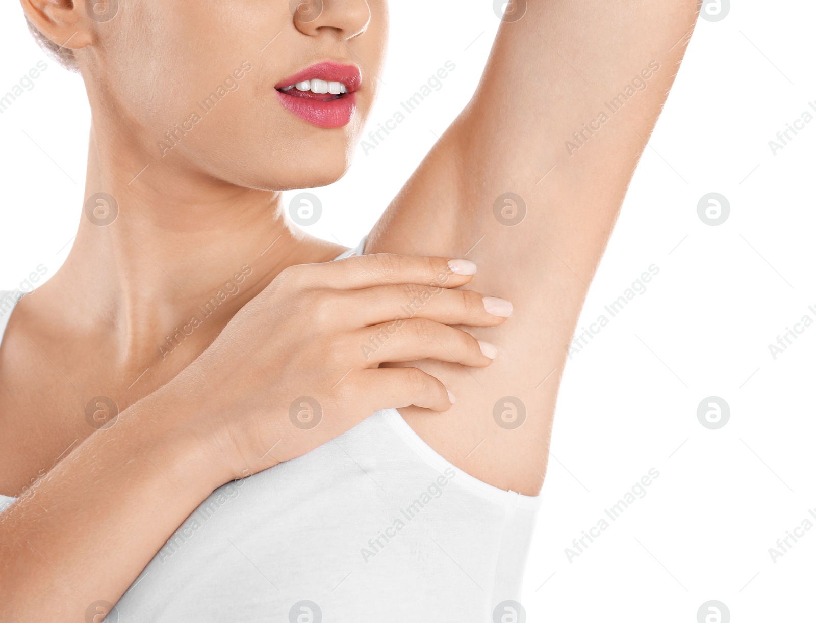 Photo of Young woman showing armpit on white background, closeup. Using deodorant