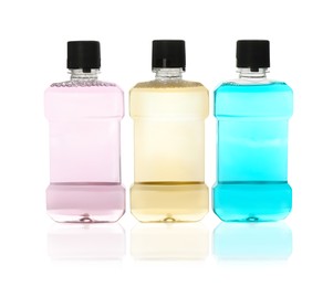 Photo of Bottles with mouthwash for teeth care on white background