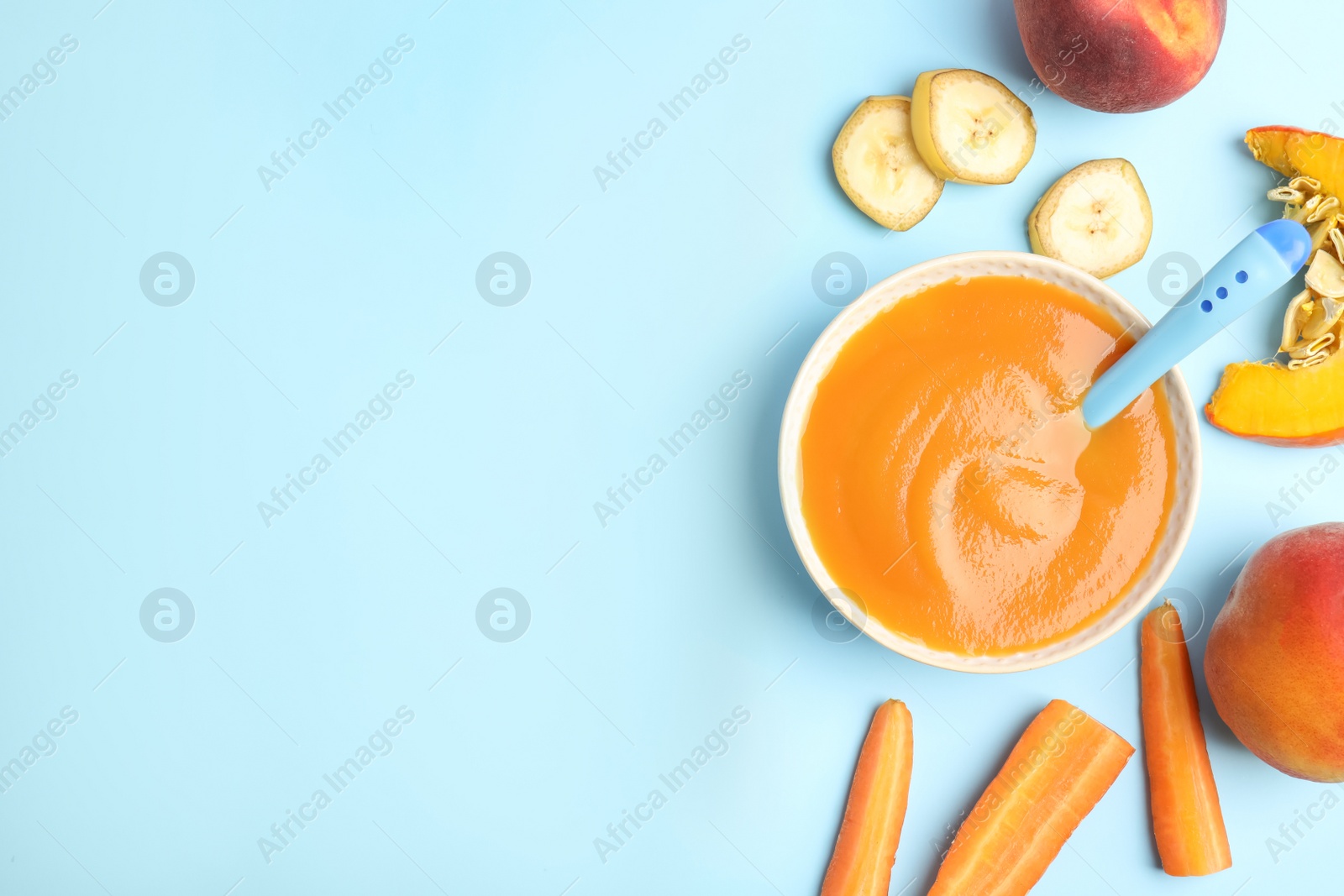 Photo of Flat lay composition with healthy baby food and ingredients on light blue background. Space for text