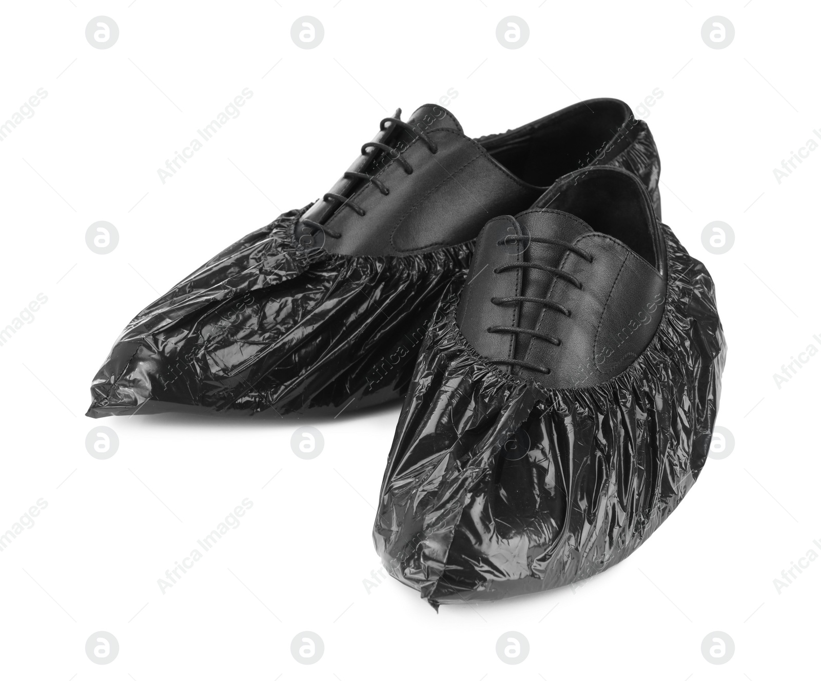 Photo of Men's shoes in black shoe covers isolated on white