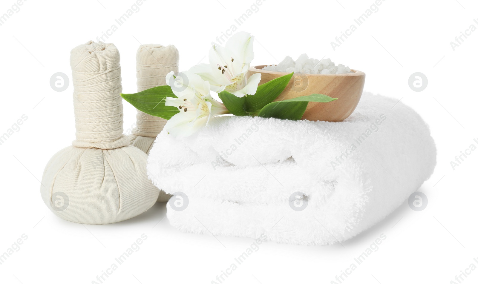 Photo of Spa composition. Towel, herbal massage bags, sea salt and beautiful flowers on white background