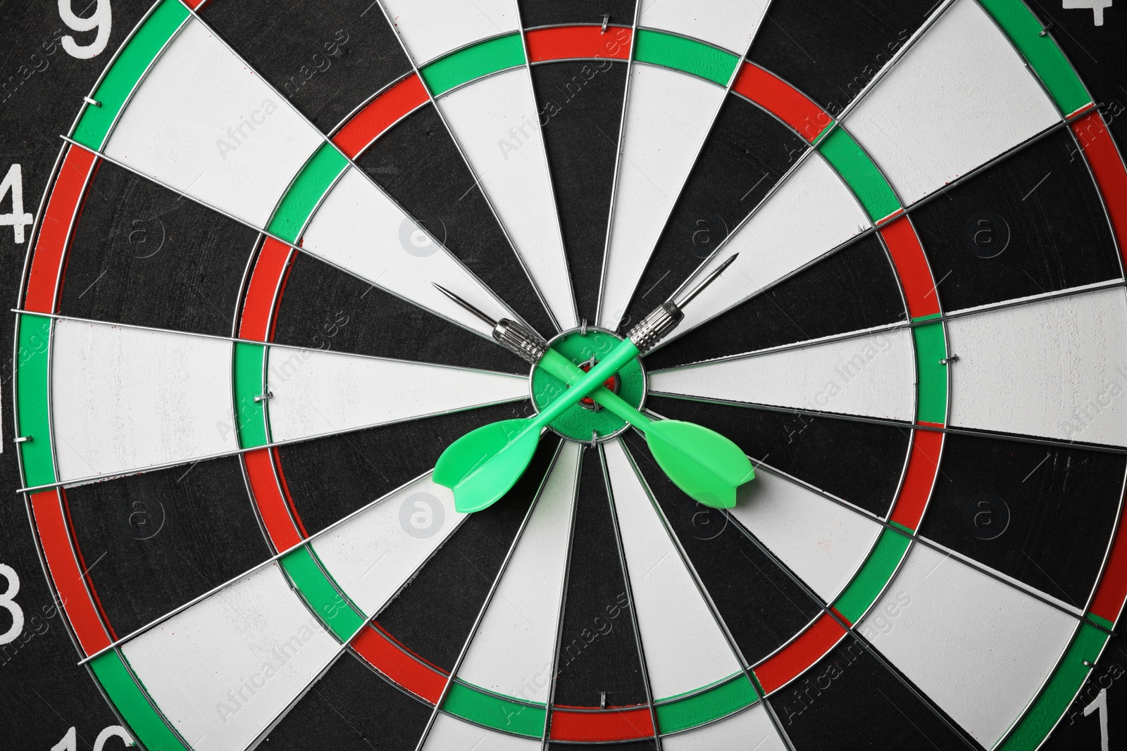 Photo of Green arrows on dart board, top view