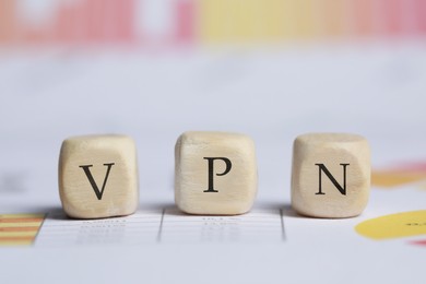 Wooden beads with acronym VPN on table