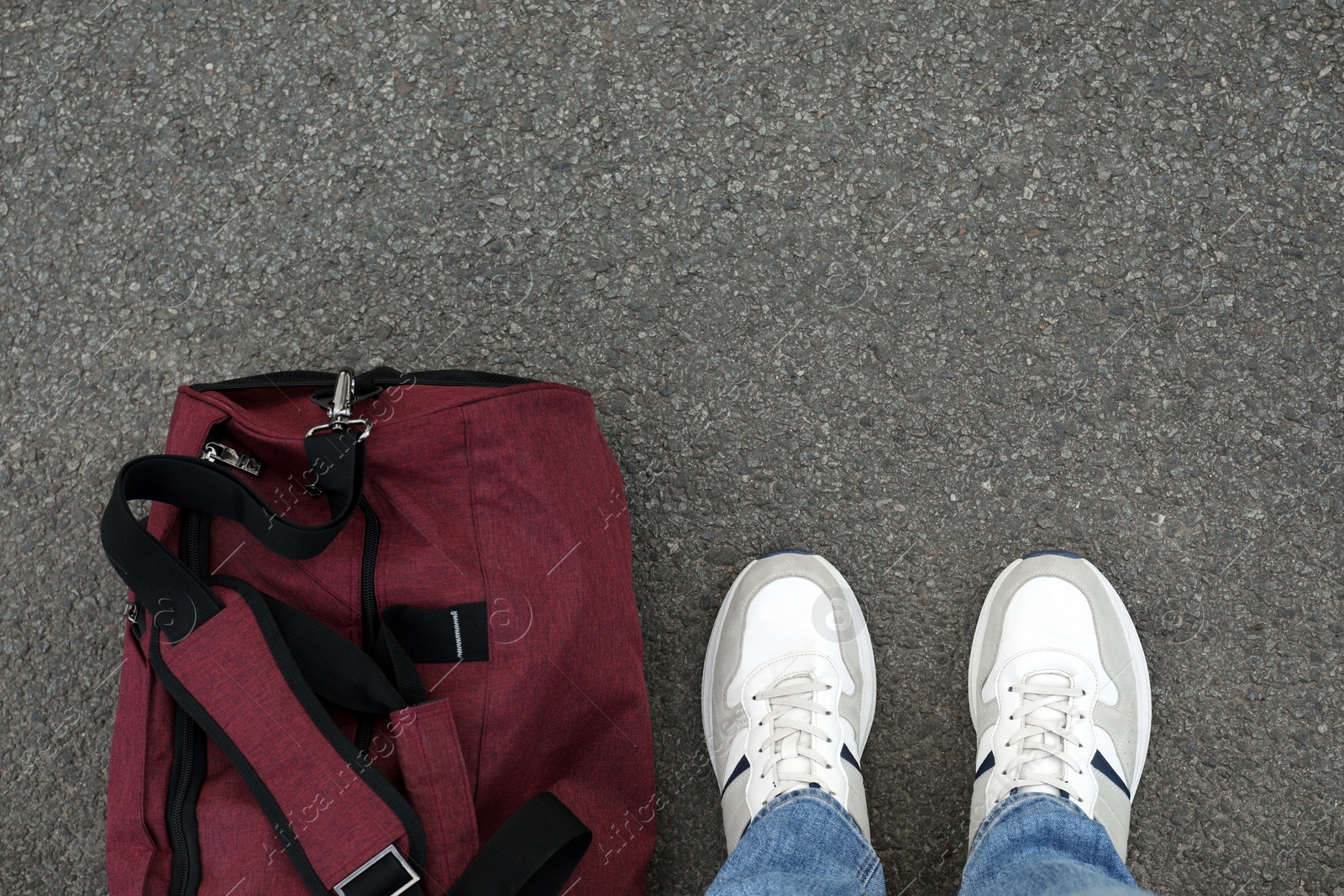 Photo of Man with bag standing on asphalt, top view