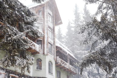 Photo of Beautiful modern hotel on snowy day. Winter vacation