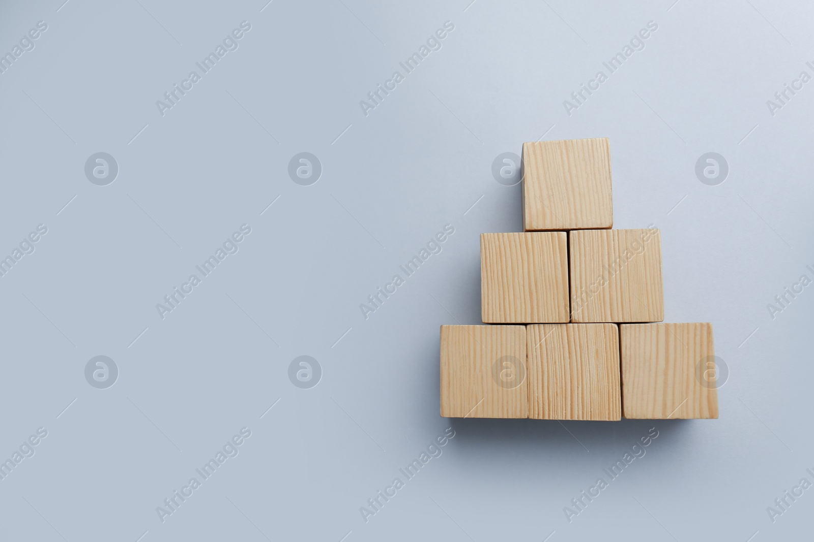 Photo of Blank wooden cubes on light background, flat lay. Space for text