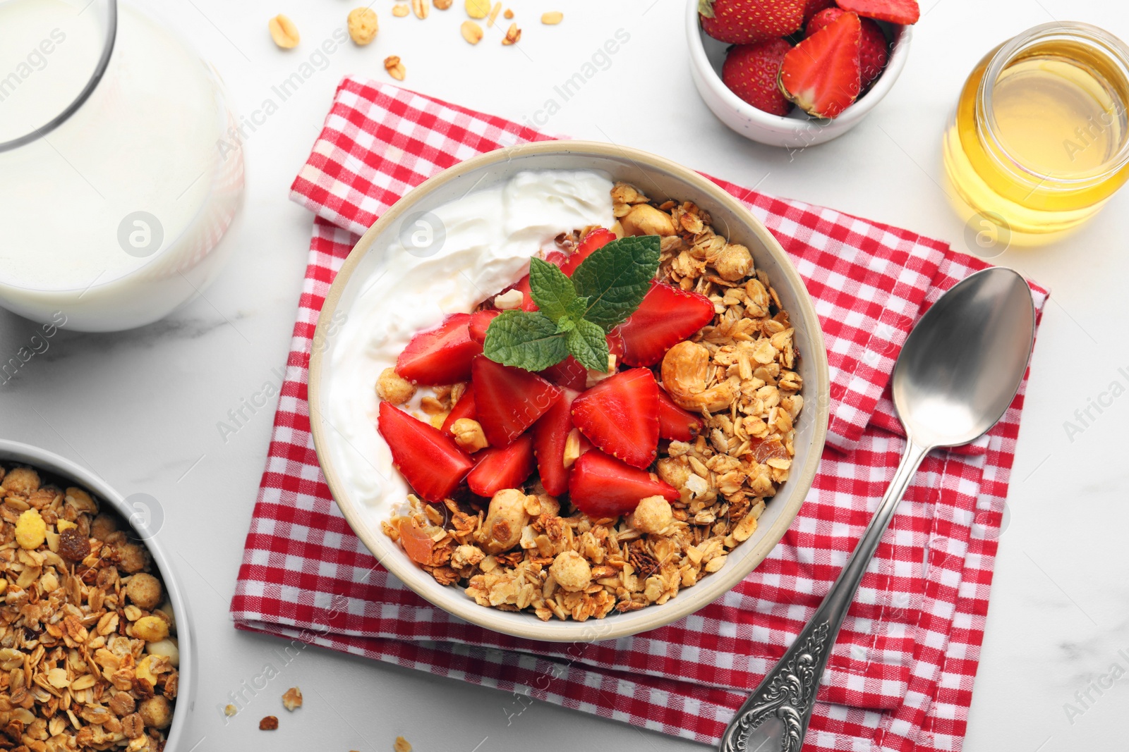 Photo of Flat lay composition with tasty granola and ingredients served on white table. Healthy meal