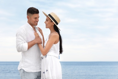 Lovely couple spending time together on beach. Space for text