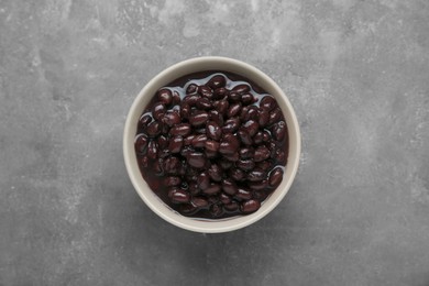 Photo of Bowl of canned kidney beans on grey table, top view