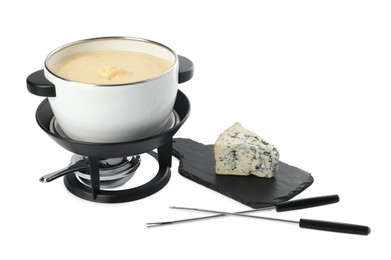 Photo of Fondue with tasty melted cheese, forks and piece isolated on white