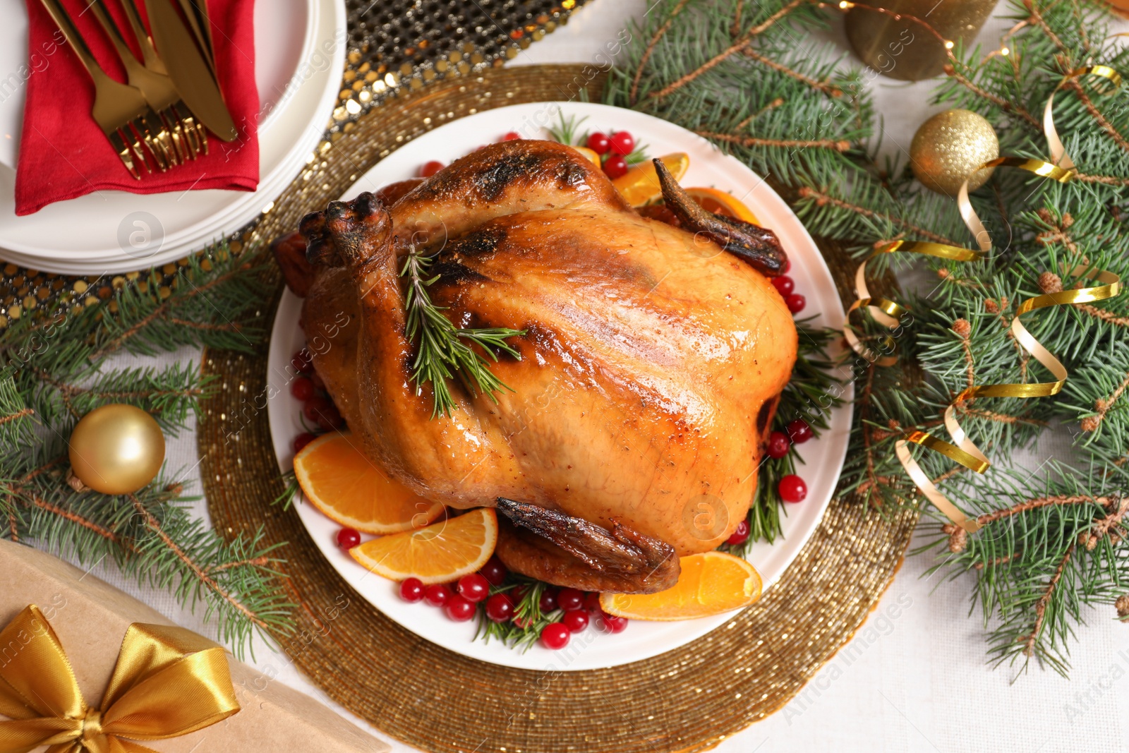 Photo of Delicious roasted turkey served for Christmas dinner on table, flat lay