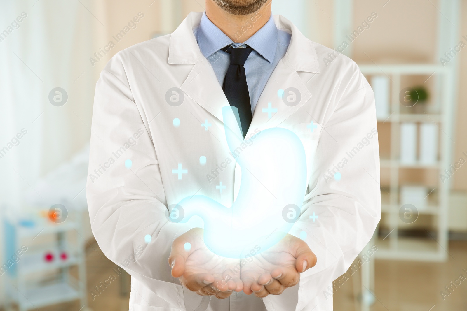 Image of Gastroenterologist holding virtual image of stomach indoors, closeup