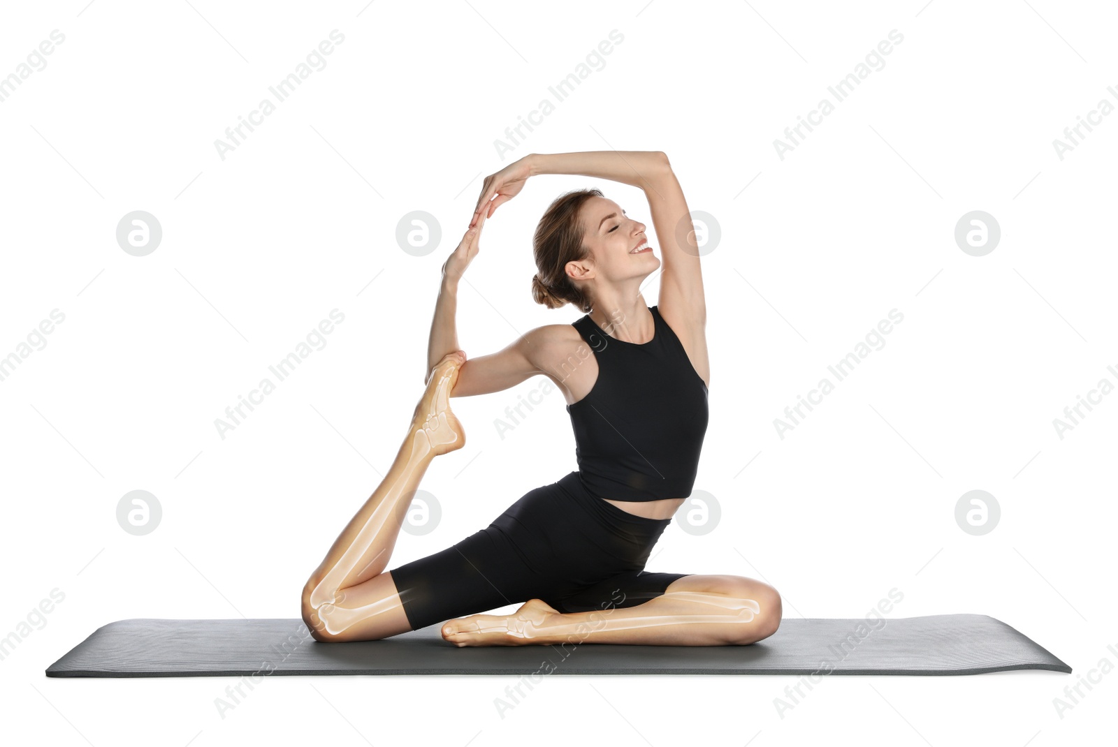Image of Digital composite of highlighted bones and young woman practicing yoga on white background