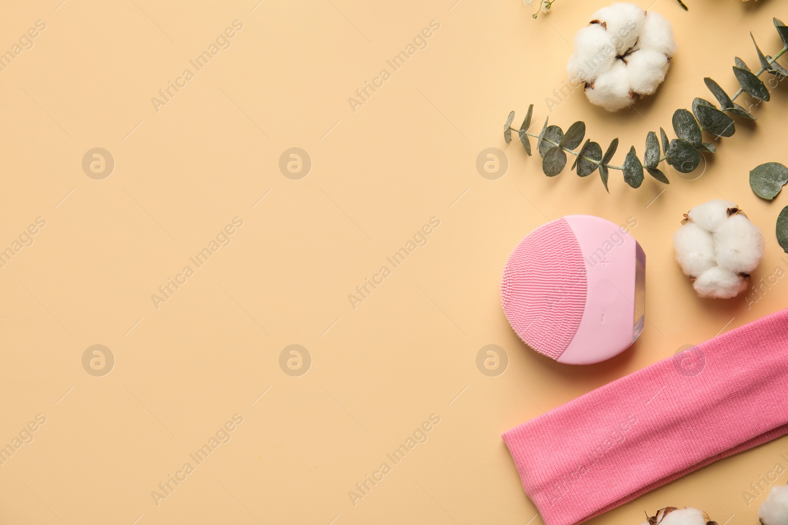 Photo of Flat lay composition with face cleansing brush on beige background. Cosmetic accessory