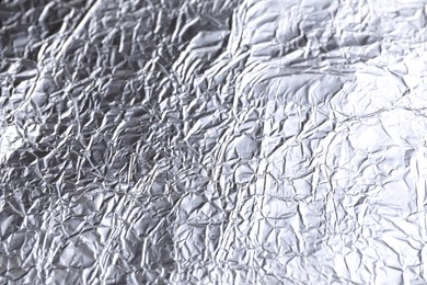 Crumpled silver foil as background, closeup view