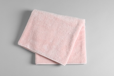 Soft folded towel on light background, top view