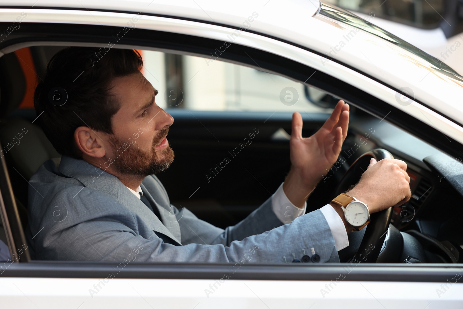 Photo of Stuck in traffic jam. Stressed driver in his car, view from outside