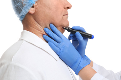 Photo of Surgeon with marker preparing man for operation against white background, closeup. Double chin removal