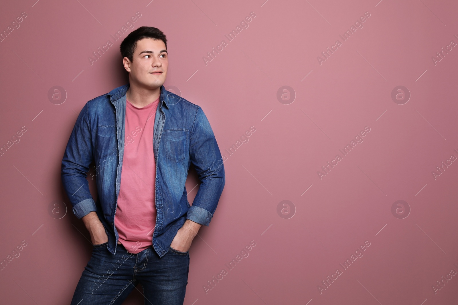 Photo of Portrait of confident young man on color background