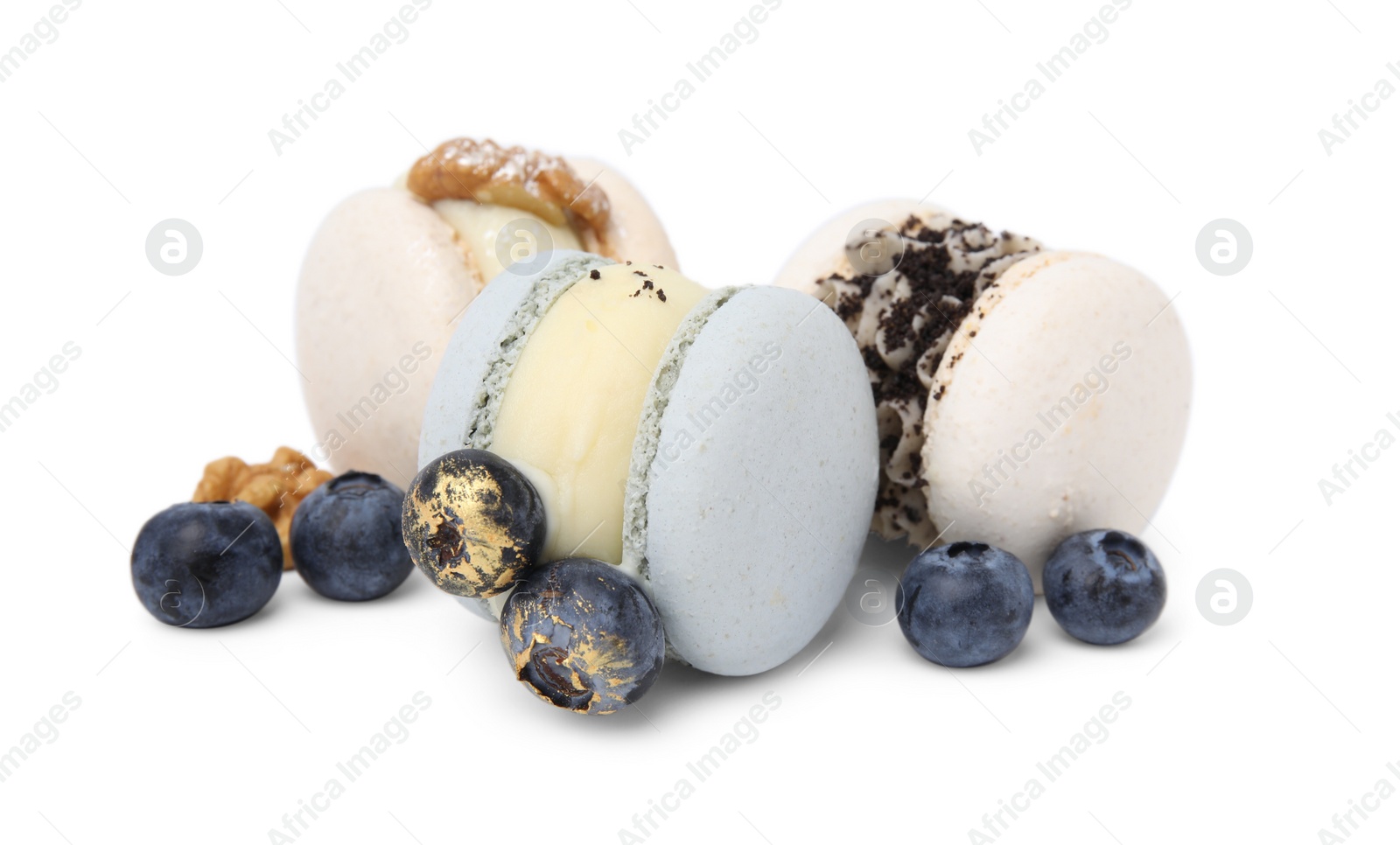 Photo of Delicious macarons, walnuts and blueberries isolated on white
