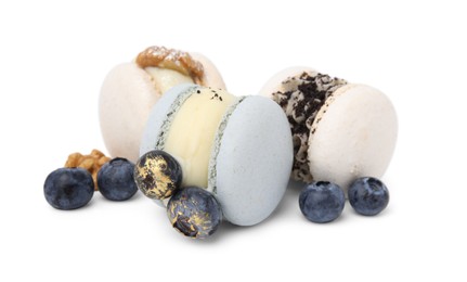 Delicious macarons, walnuts and blueberries isolated on white