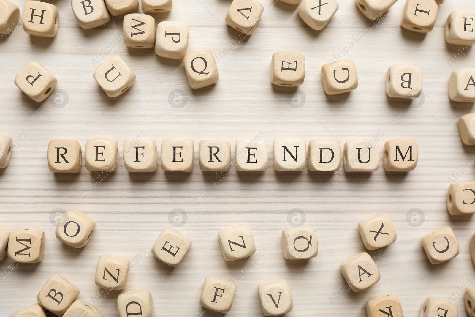 Photo of Word Referendum of cubes on white wooden table, flat lay