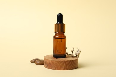 Photo of Composition with bottle of cosmetic serum on beige background