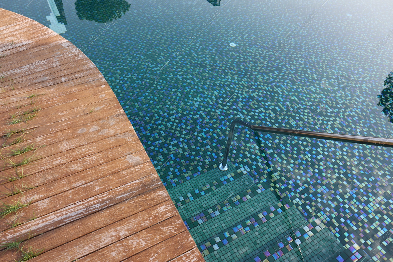 Photo of Outdoor swimming pool with steps and rail at resort