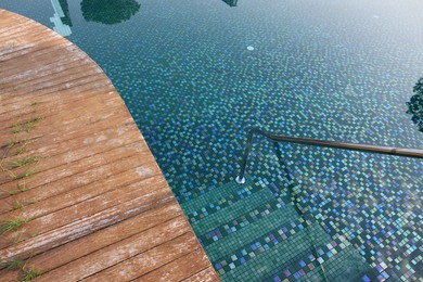 Outdoor swimming pool with steps and rail at resort