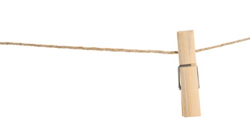 Wooden clothespin on rope against white background