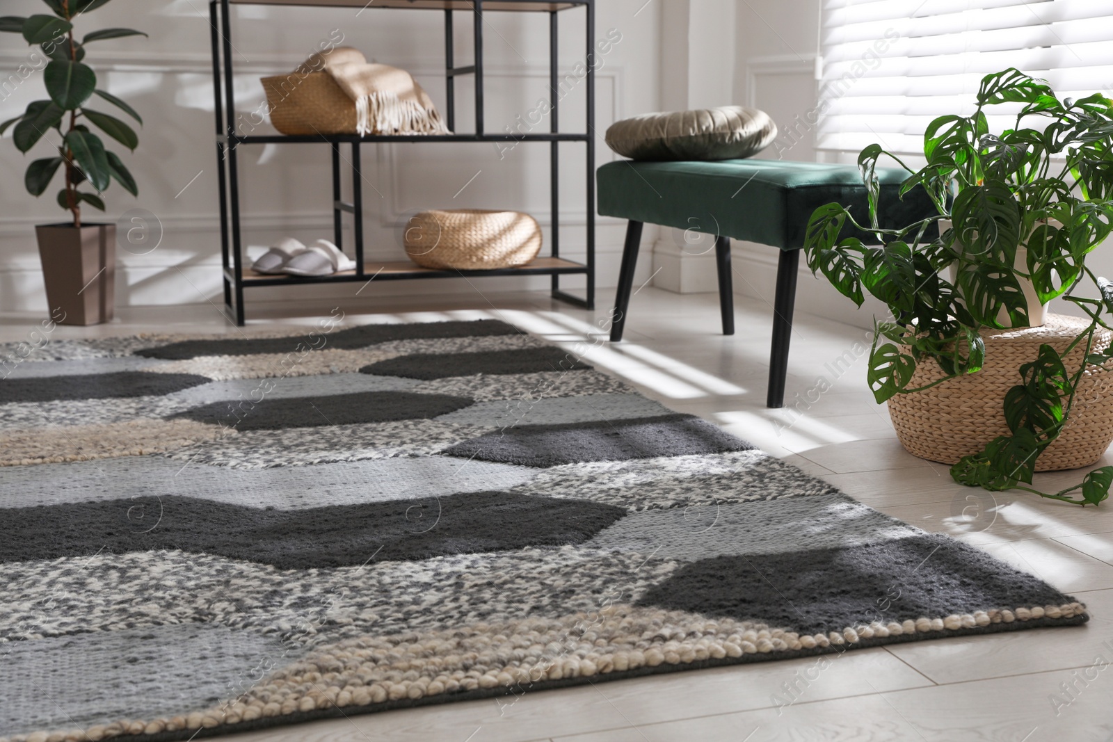 Photo of Stylish carpet with pattern on floor in room