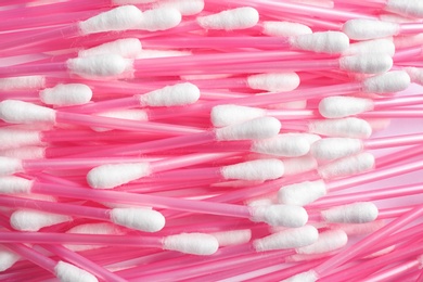 Pile of cotton swabs as background, top view