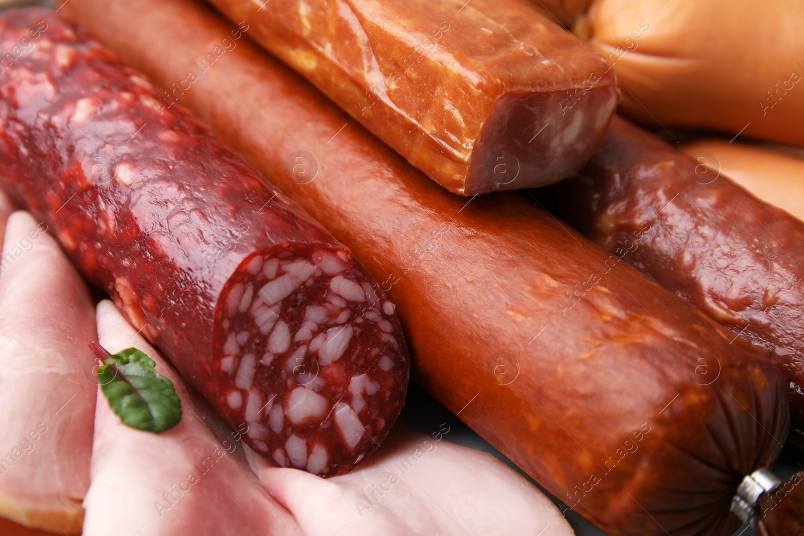 Photo of Different types of tasty sausages as background, closeup