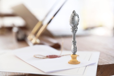 Photo of Vintage notary stamp and documents on desk with space for text, closeup