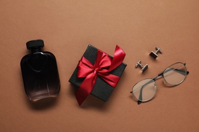 Photo of Luxury perfume, gift box and men accessories on brown background, flat lay. Father's day celebration