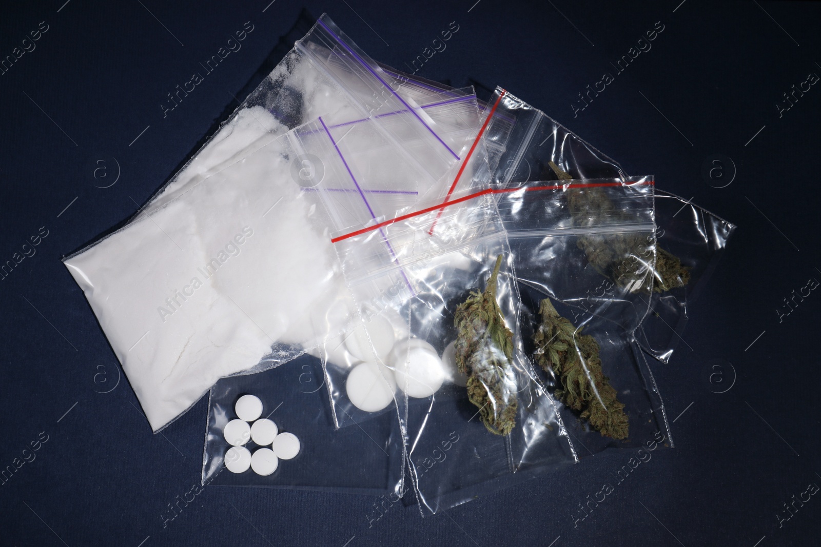 Photo of Cocaine, dried hemp and ecstasy on dark background, top view