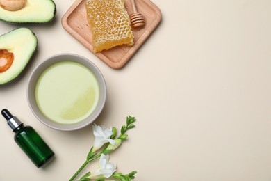 Homemade hair mask and ingredients on beige background, flat lay. Space for text