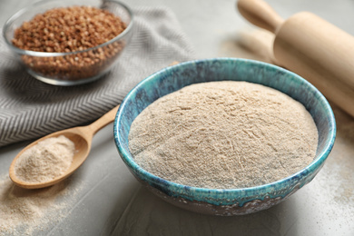 Buckwheat flour in bowl on light table