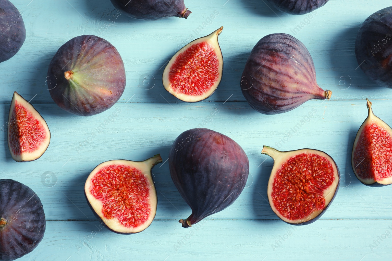 Photo of Fresh ripe figs on wooden background, top view