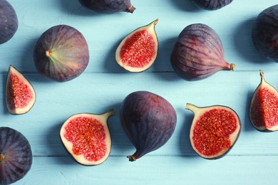 Fresh ripe figs on wooden background, top view