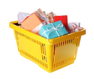 Shopping basket full of gift boxes on white background