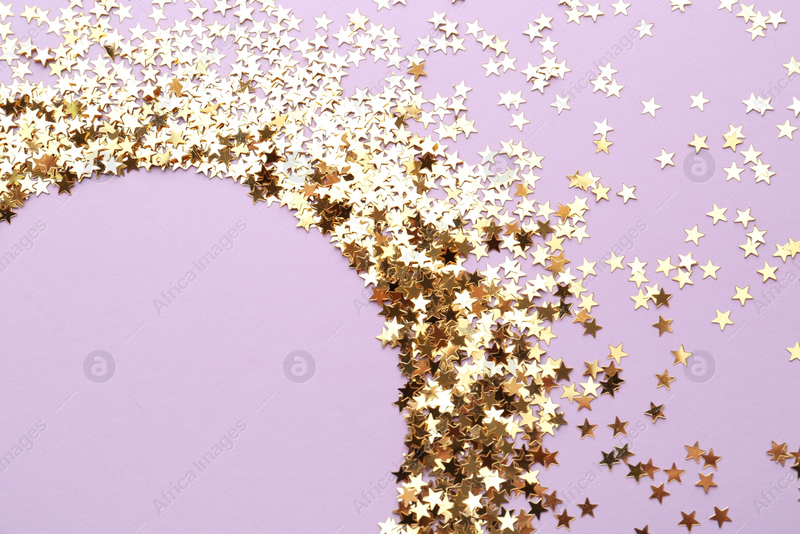 Photo of Confetti stars on violet background, flat lay with space for text. Christmas celebration