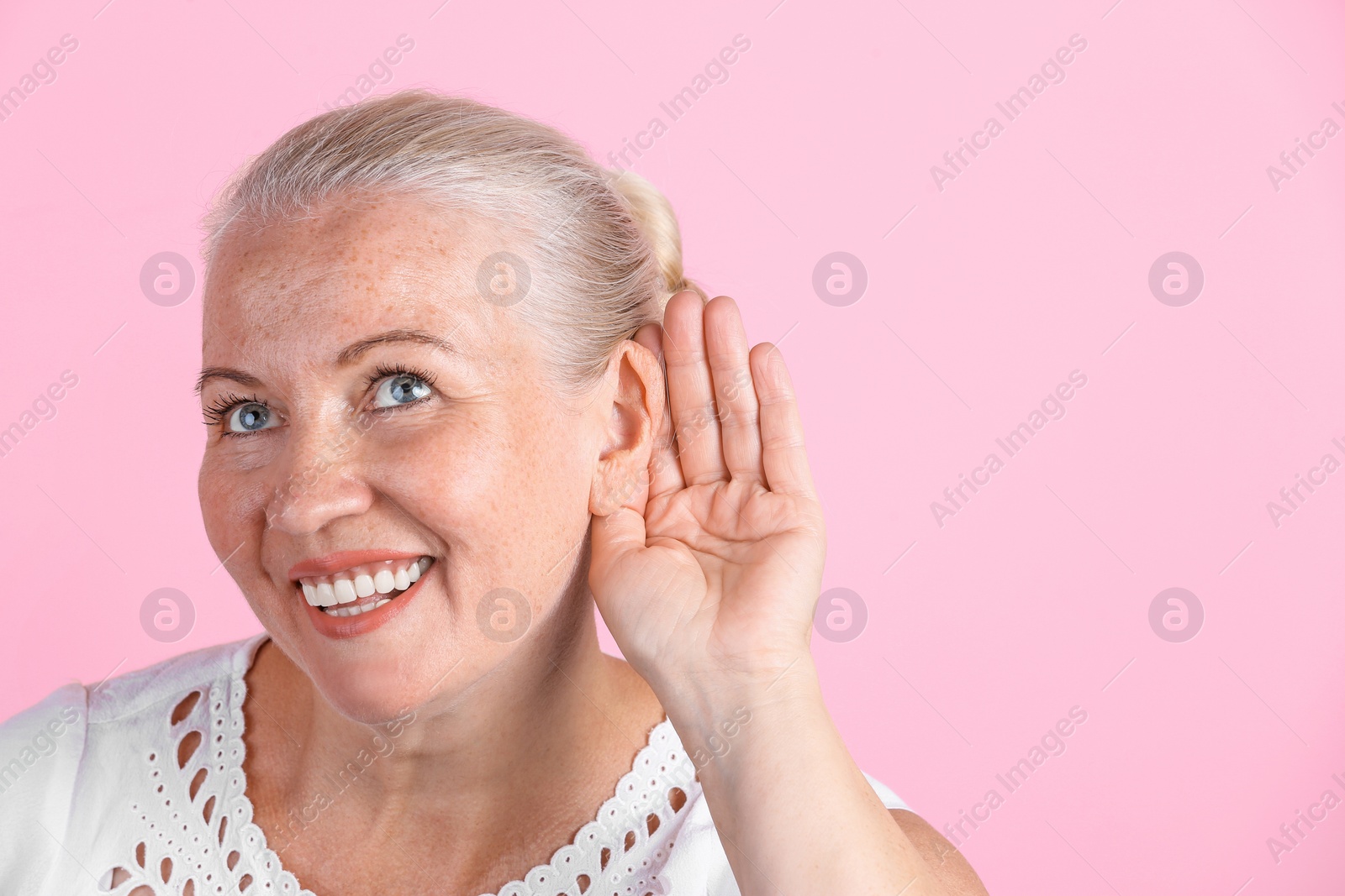 Photo of Mature woman with hearing problem on color background