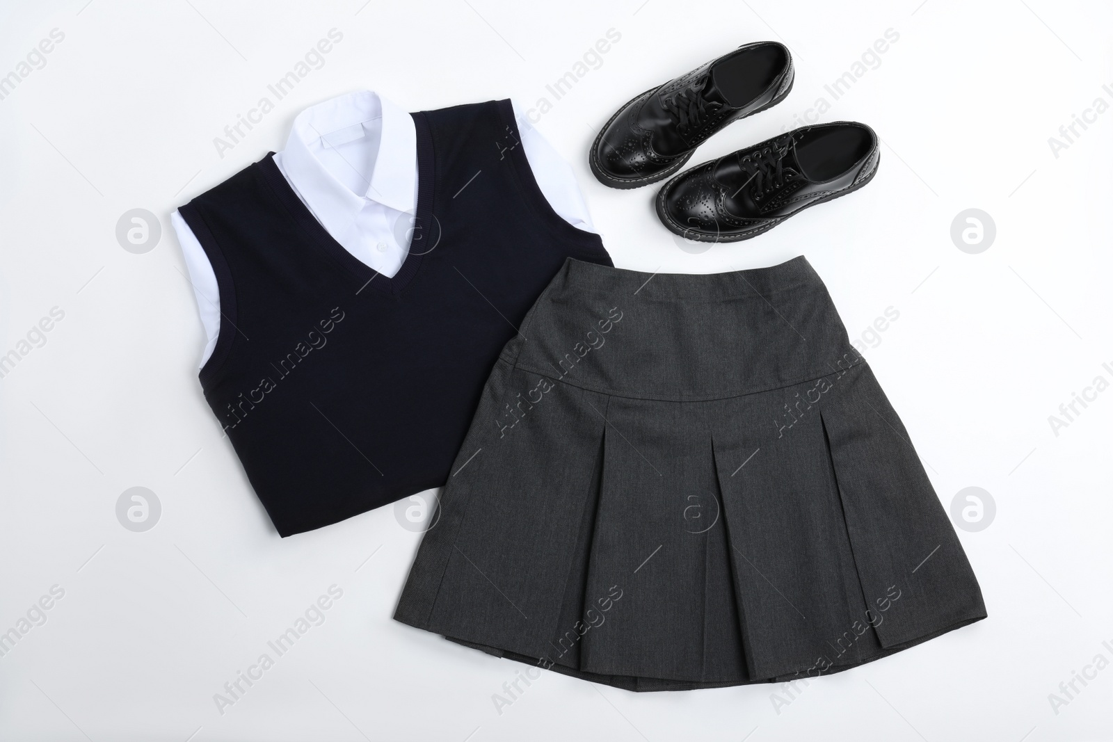 Photo of School uniform for girl on white background, top view